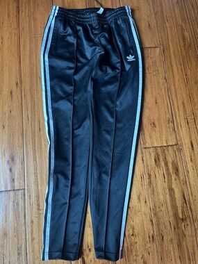 Unisex Adidas Black Joggers with White  Strip- faint Adidas pattern throughout.